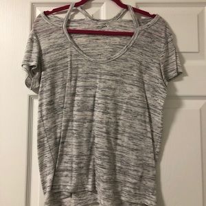 White and grey t-shirt with shoulder cutouts.